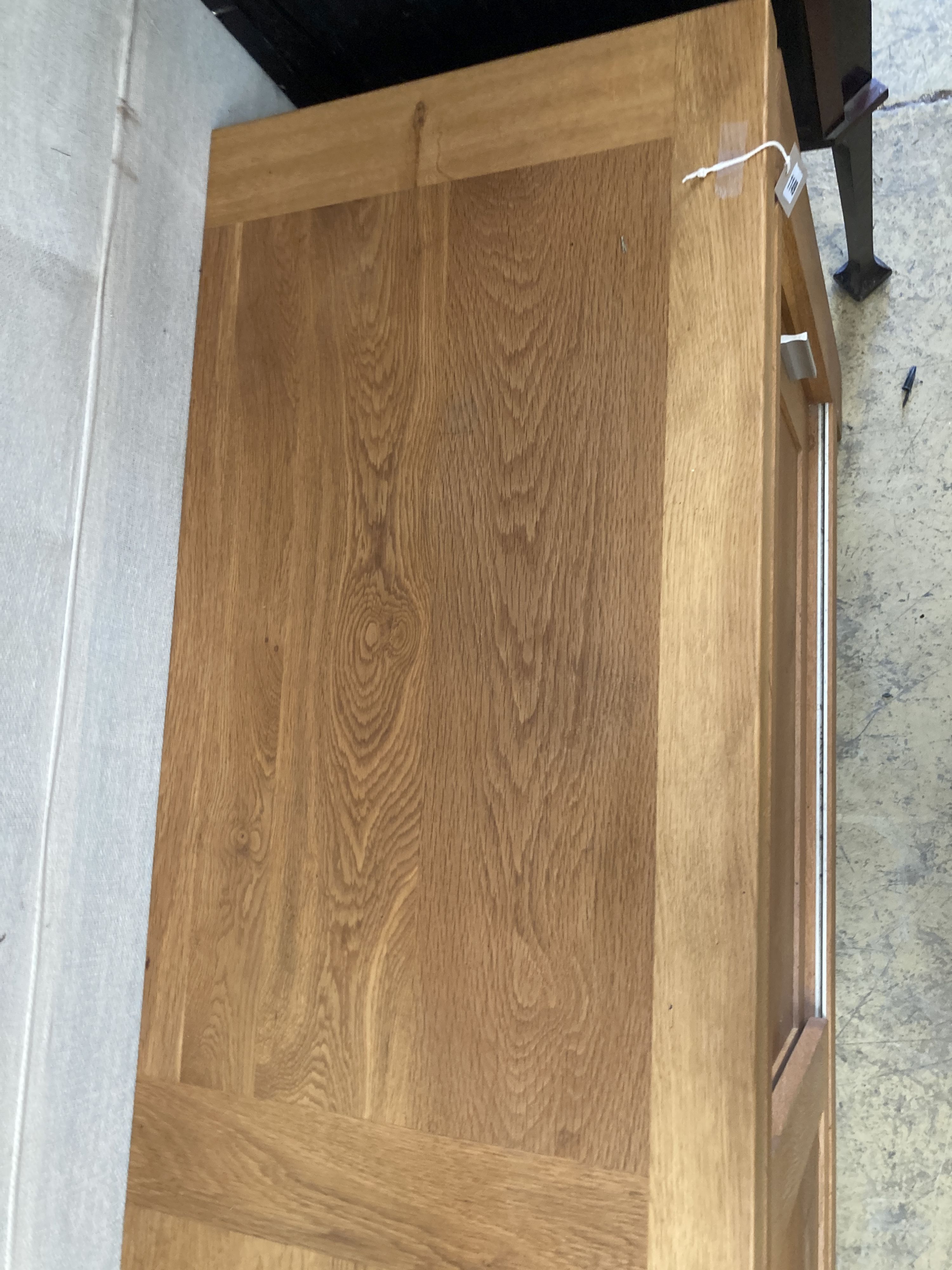 A contemporary light oak sliding door sideboard, length 178cm, depth 50cm, height 78cm